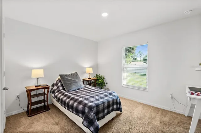 a bedroom with a bed and a flat tv screen in it