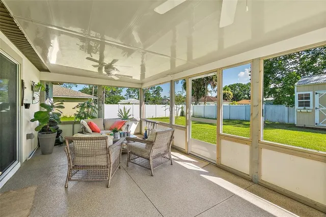 a living room with furniture and flowers