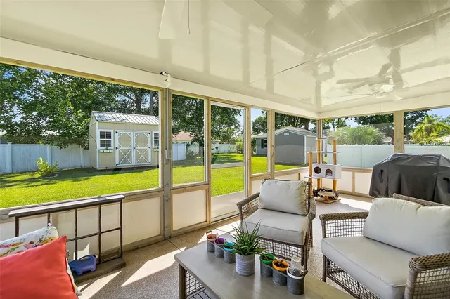 a view of a backyard with large trees and wooden fence