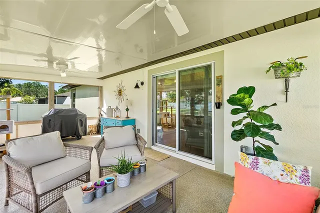 a swimming pool with outdoor seating and yard