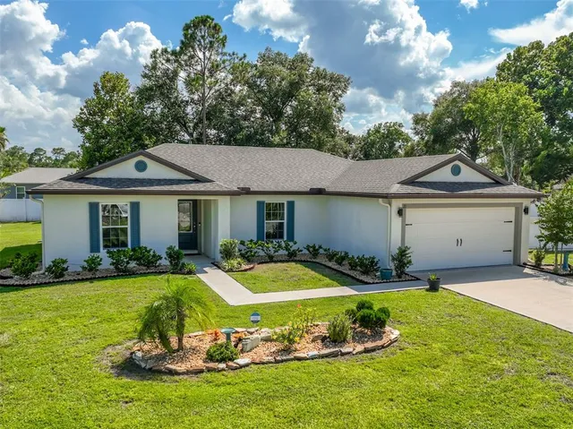 a view of an house with backyard space and garden