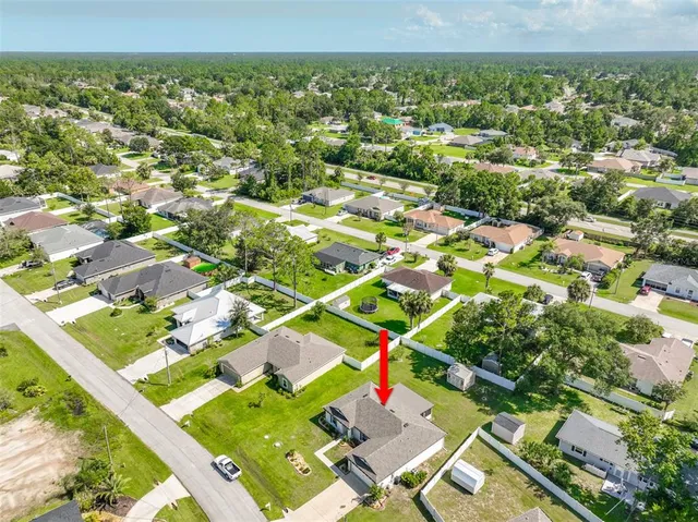 an aerial view of residential houses with outdoor space and swimming pool