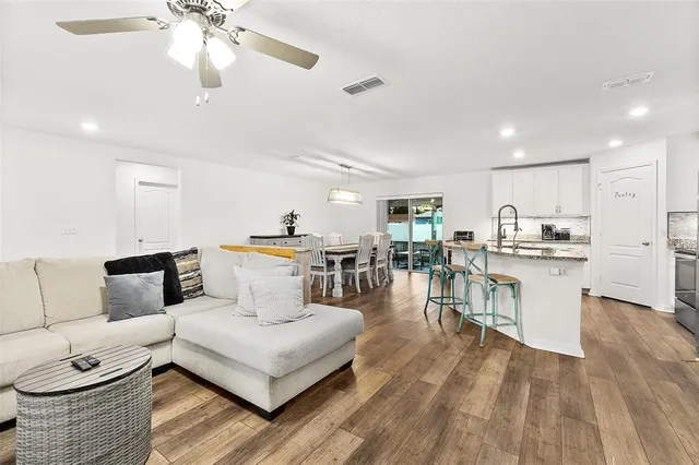 a living room with furniture and kitchen view