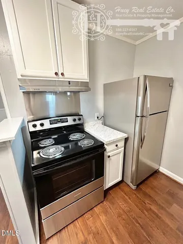 a stove top oven sitting inside of a kitchen