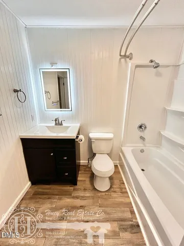 a bathroom with a bathtub shower sink and toilet