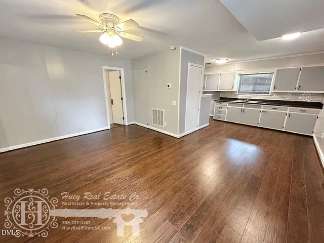 a view of kitchen with sink and wooden floor