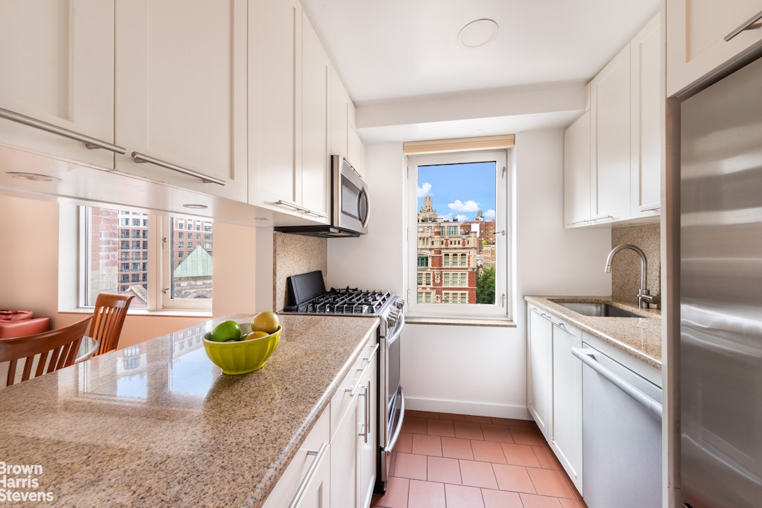 2373 Broadway, Unit 930 Manhattan, NY 10024 - Photo 2 of 12 a kitchen with stove cabinets and living room