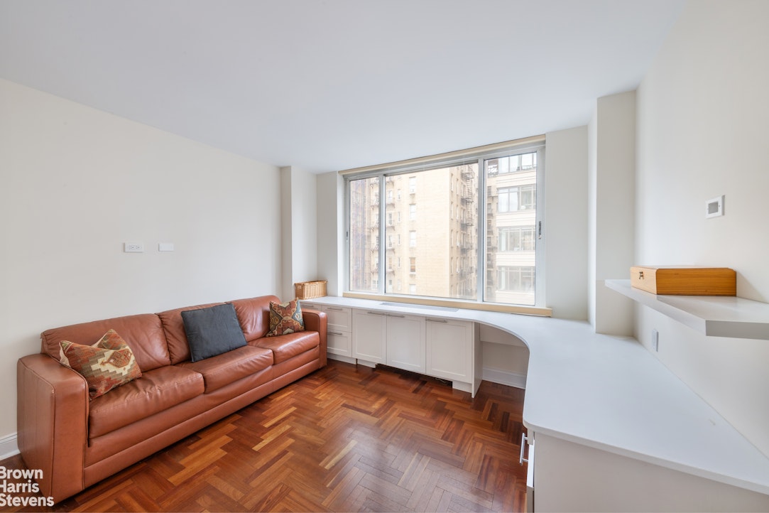 2373 Broadway, Unit 930 Manhattan, NY 10024 - Photo 5 of 12 a living room with furniture and a window