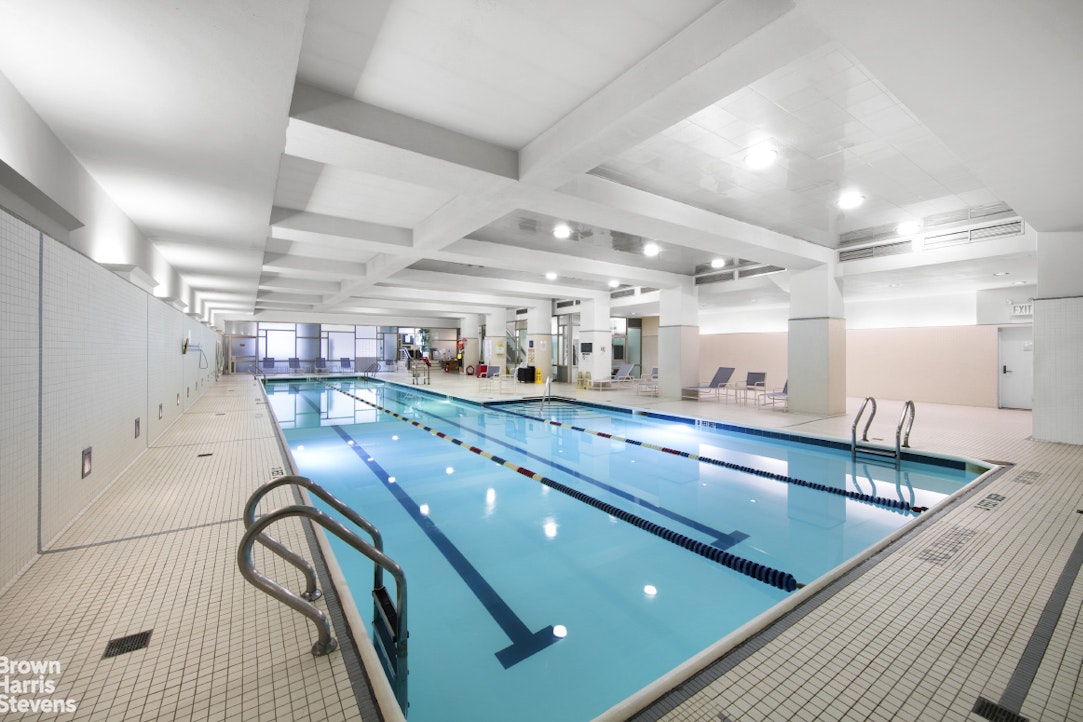 2373 Broadway, Unit 930 Manhattan, NY 10024 - Photo 8 of 12 a kitchen with counter top space a sink and stainless steel appliances