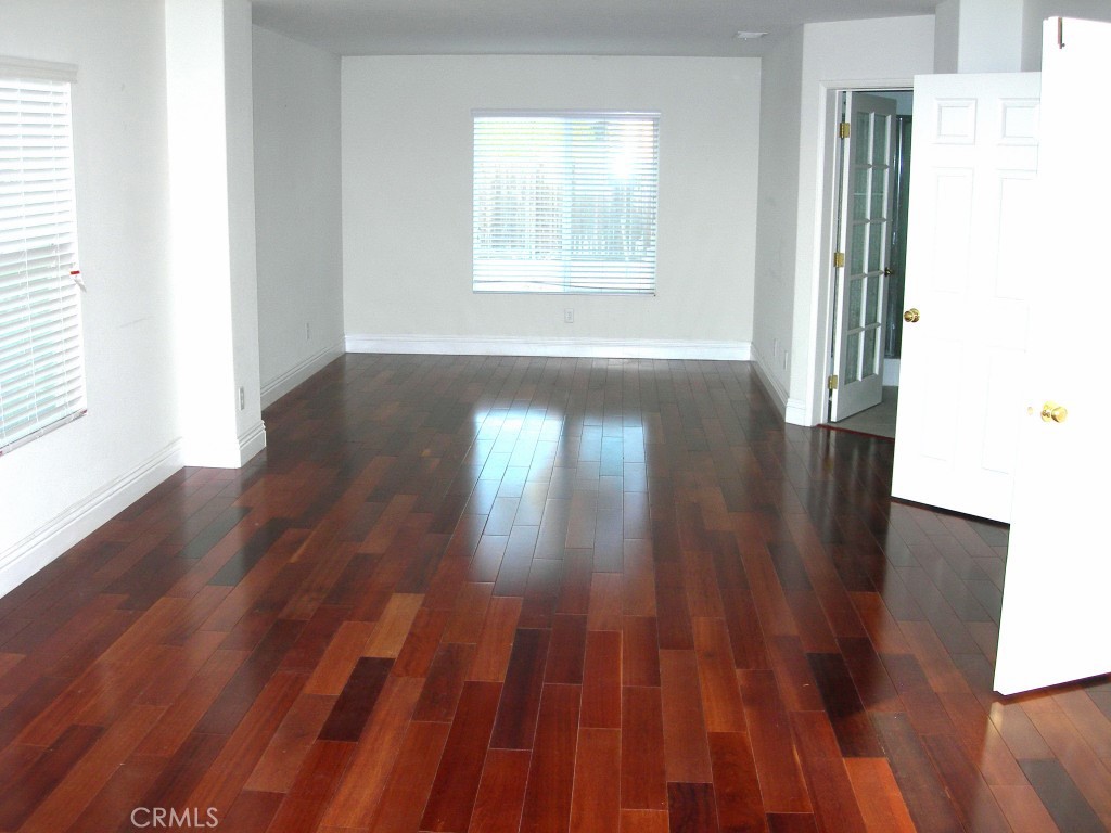 11410 Fitzpatrick Drive Rancho Cucamonga, CA 91730 - Photo 12 of 22 an empty room with wooden floor and windows