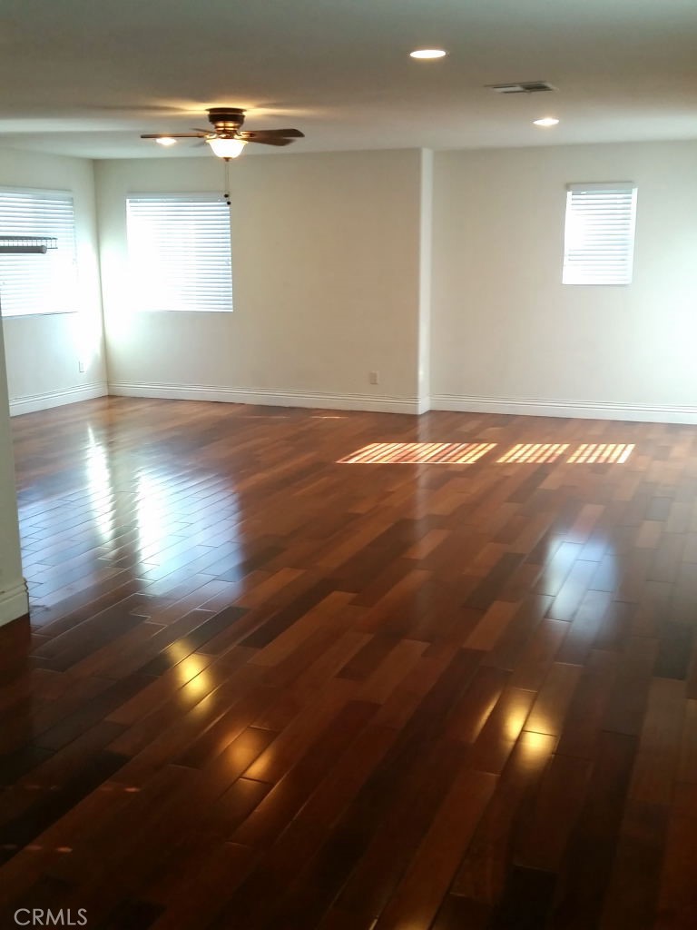 11410 Fitzpatrick Drive Rancho Cucamonga, CA 91730 - Photo 17 of 22 an empty room with wooden floor and windows