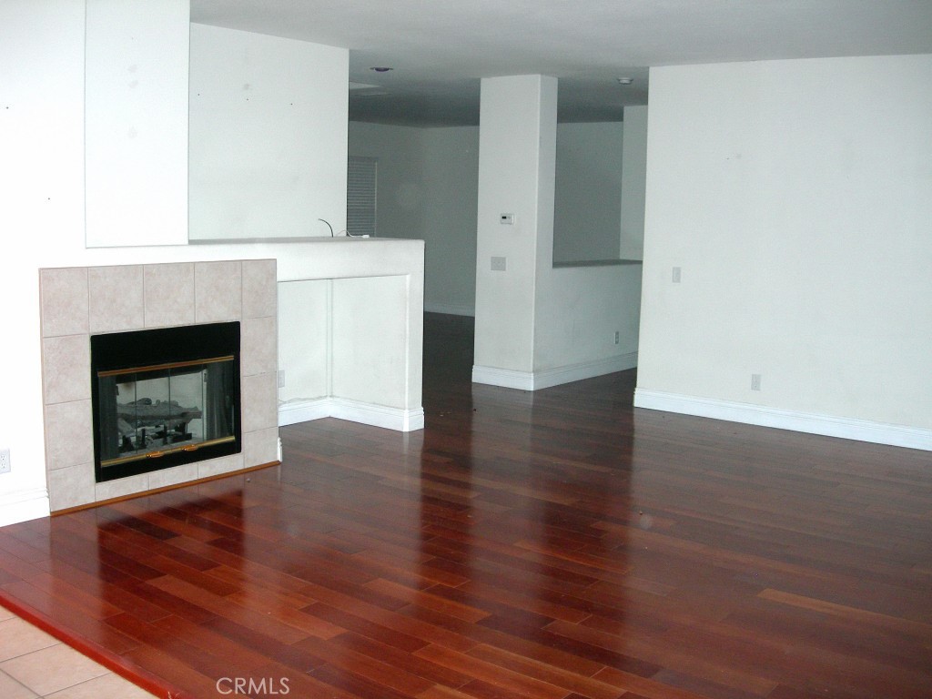 11410 Fitzpatrick Drive Rancho Cucamonga, CA 91730 - Photo 5 of 22 a view of a livingroom with wooden floor and a fireplace