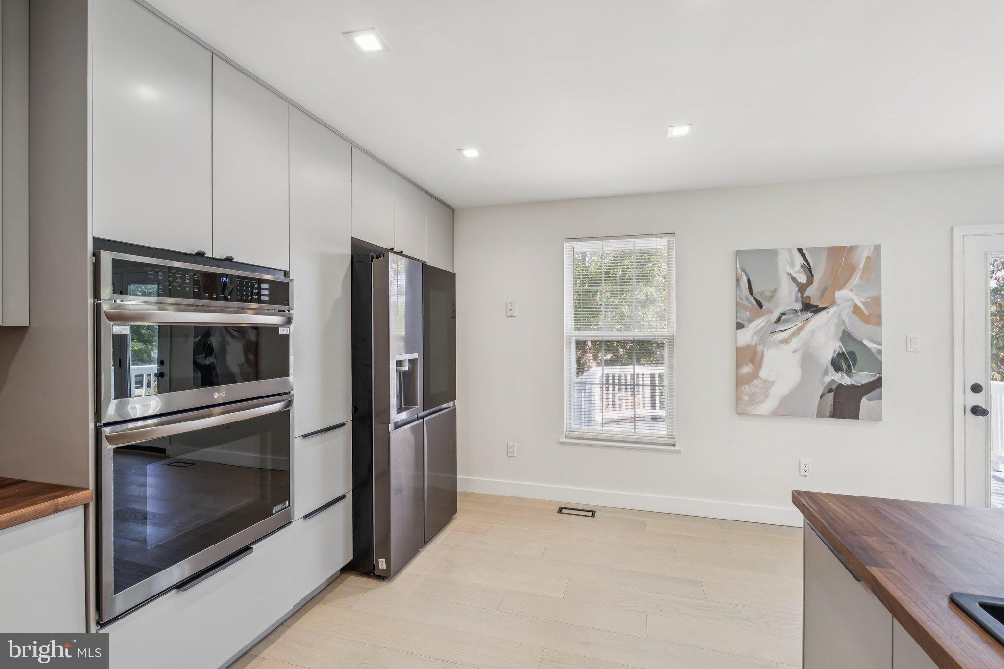 43501 Postrail Square Ashburn, VA 20147 - Photo 11 of 35 a kitchen with stainless steel appliances granite countertop a refrigerator and a stove top oven