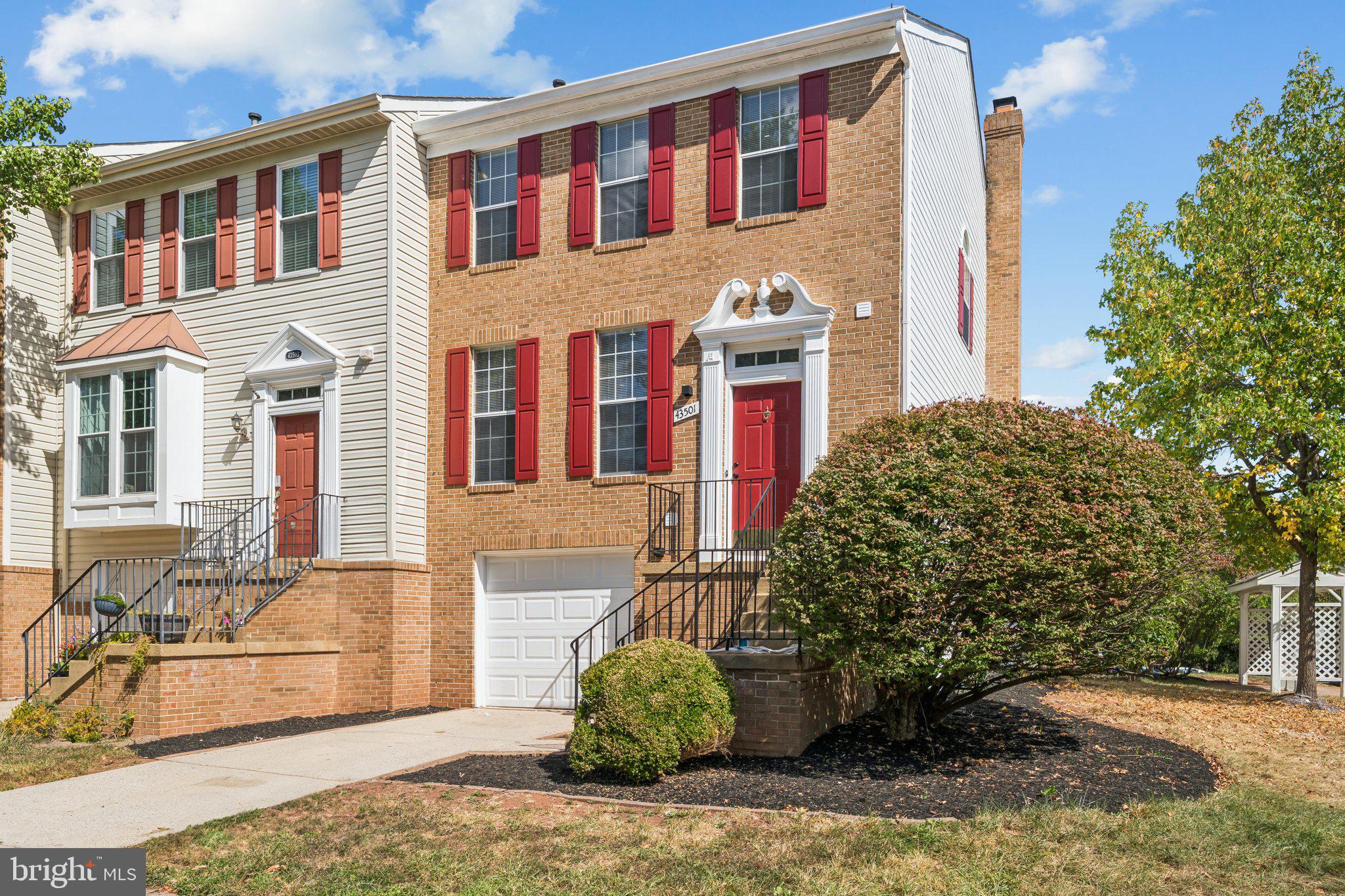 43501 Postrail Square Ashburn, VA 20147 - Photo 2 of 35 a front view of a house with a garden