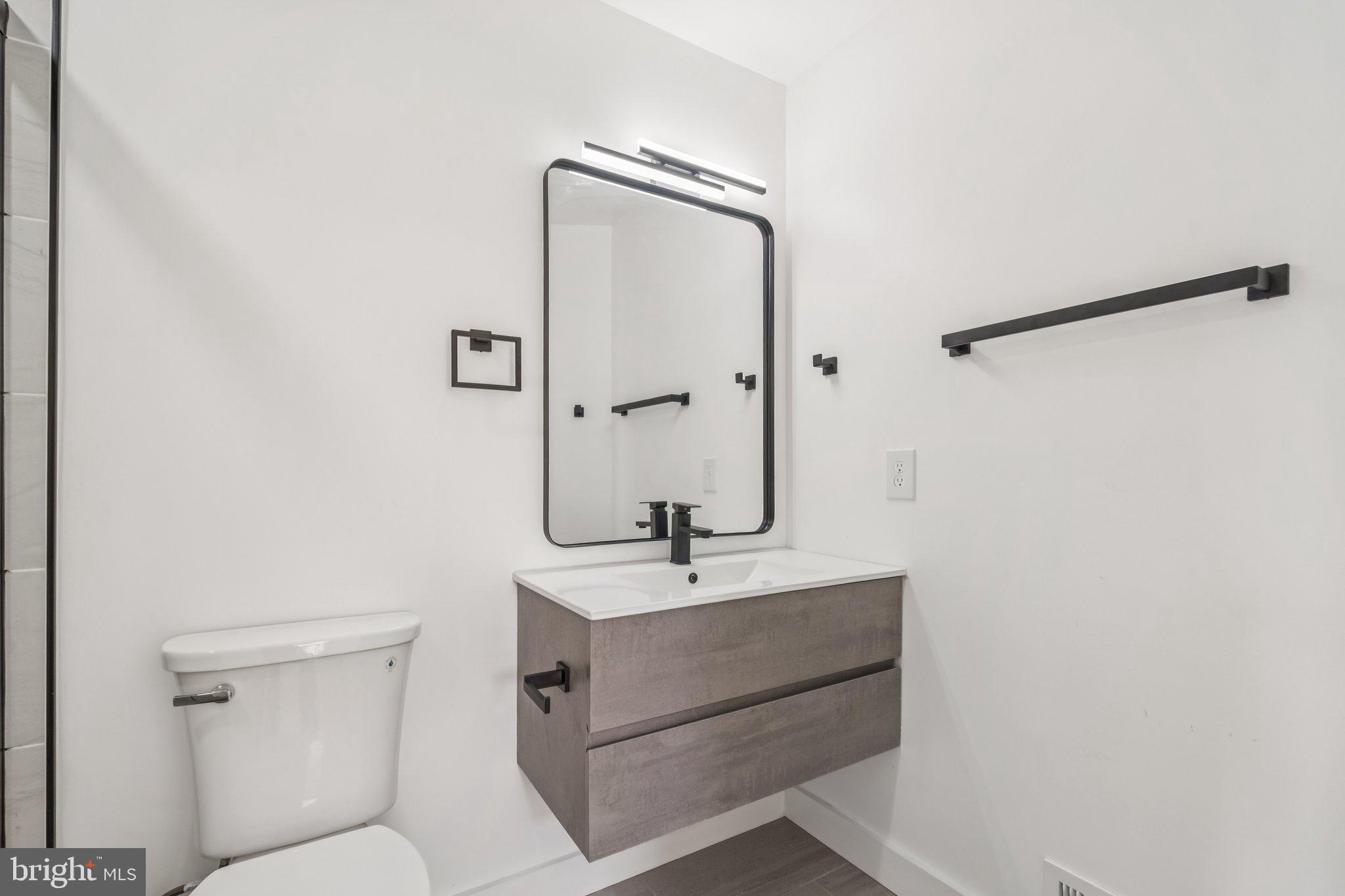 43501 Postrail Square Ashburn, VA 20147 - Photo 24 of 35 a bathroom with a sink mirror vanity and toilet