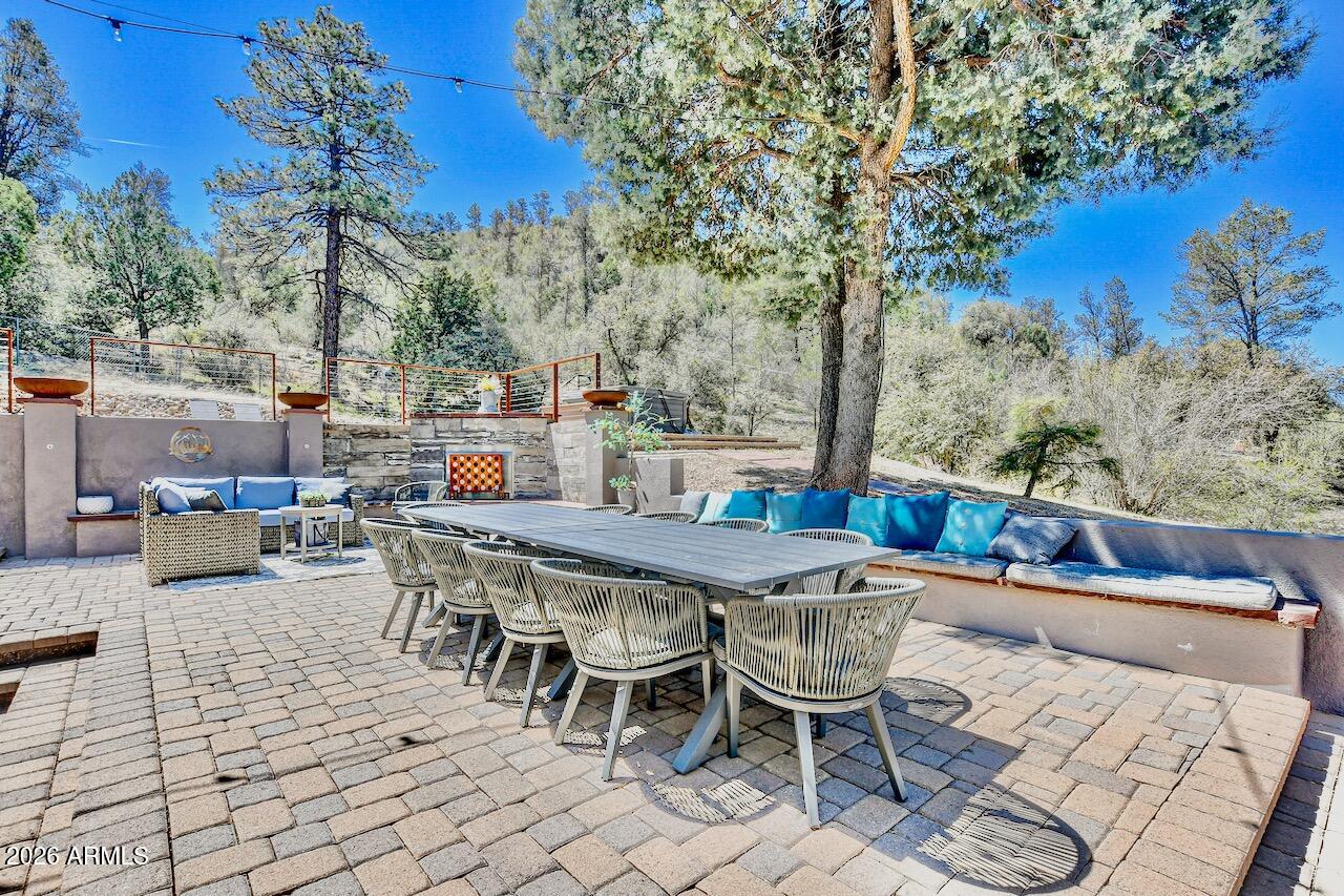 3000 Shadow Valley Ranch Road Prescott, AZ 86305 - Photo 11 of 70 a view of a patio with a dining table and chairs with wooden fence