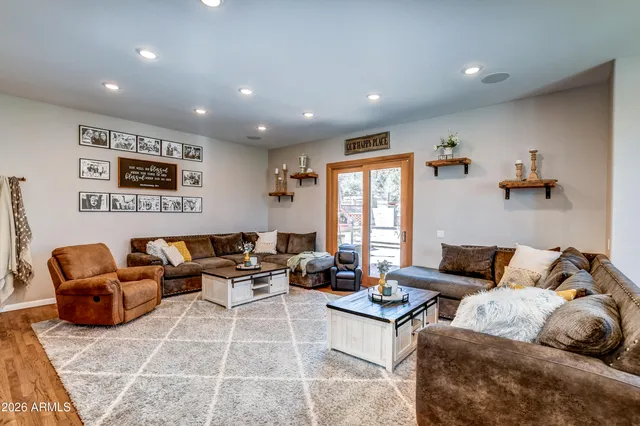 a living room with furniture and large windows