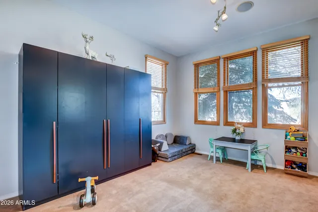 a bathroom with a granite countertop shower a mirror and a toilet