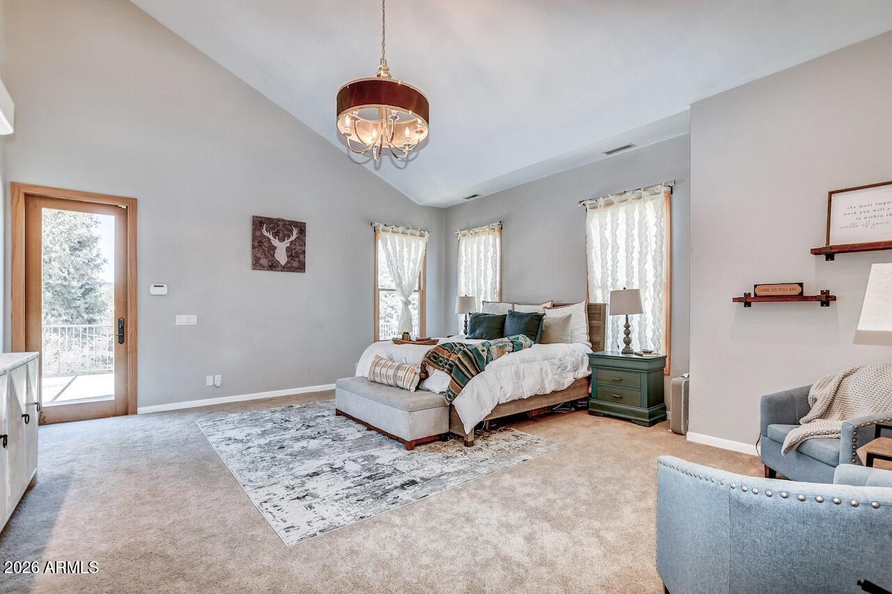 3000 Shadow Valley Ranch Road Prescott, AZ 86305 - Photo 35 of 70 a spacious bedroom with a bed and a chandelier