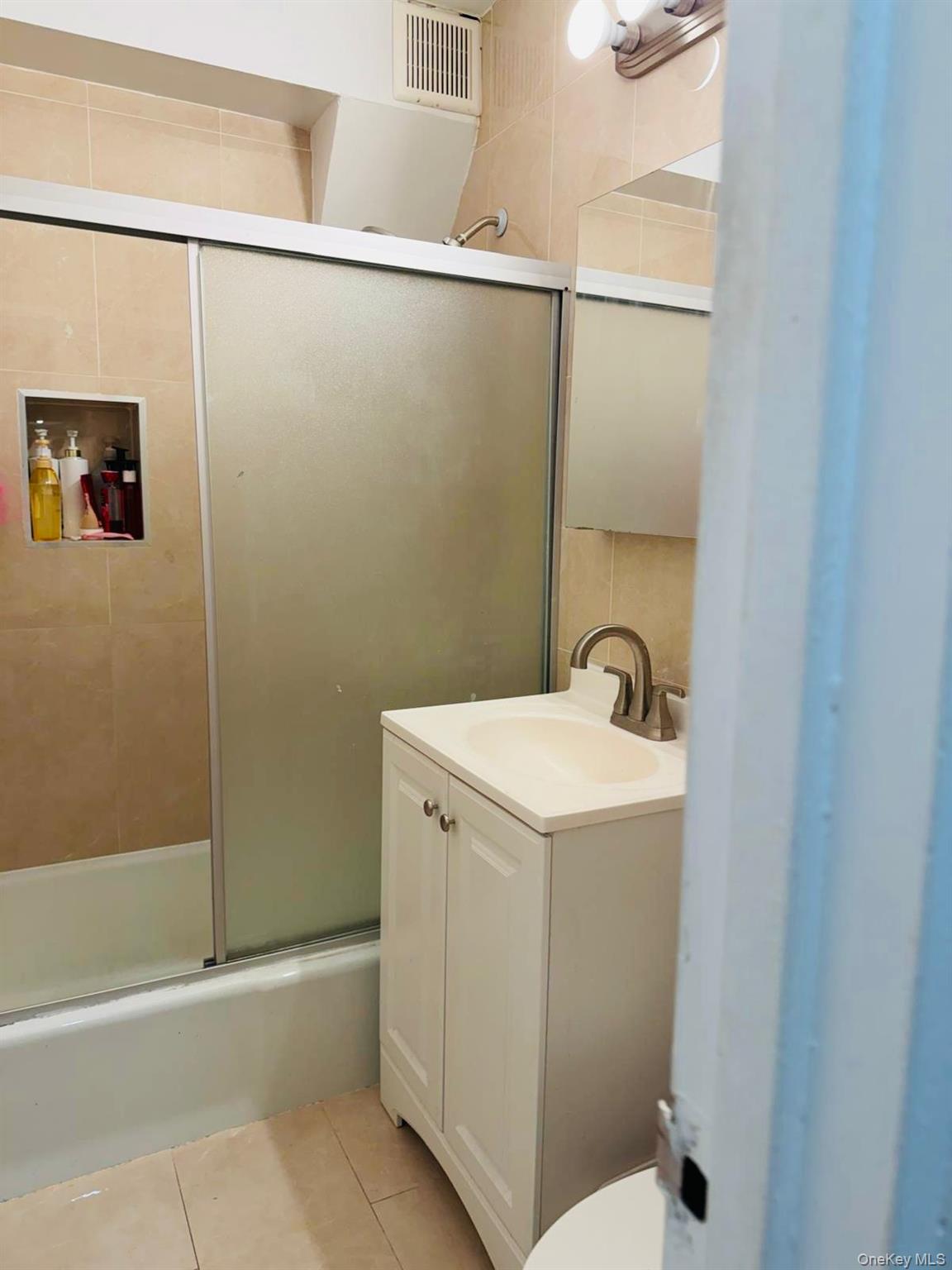 58-03 Calloway Street, Unit 6FF Queens, NY 11368 - Photo 6 of 6 a bathroom with a sink and mirror