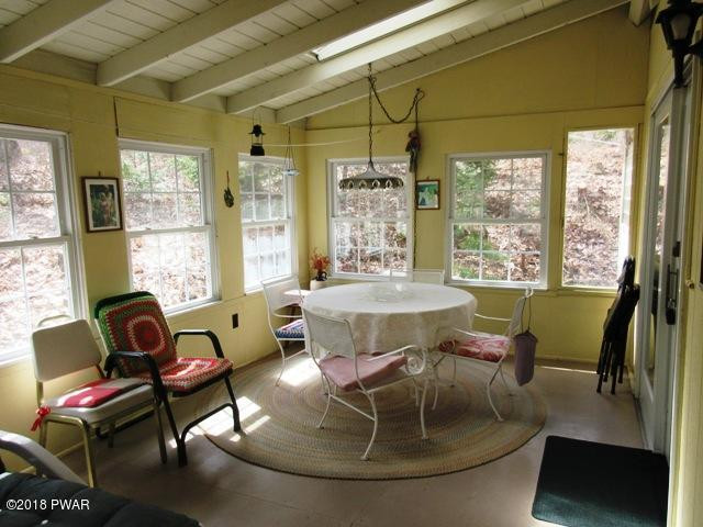 208 Rodeo Drive Hawley, PA 18428 - Photo 2 of 15 a living room with furniture and a floor to ceiling window