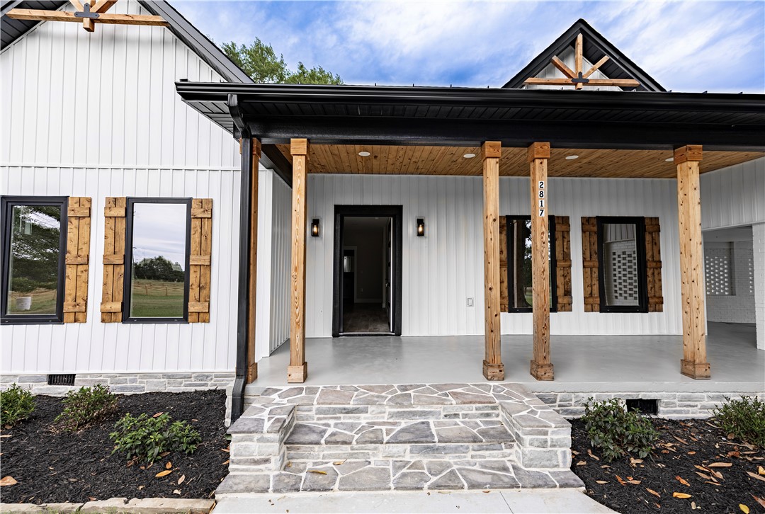 2817 Broadway Lake Road Anderson, SC 29621 - Photo 2 of 41 A welcoming stone entryway invites you into this charming home with natural wood accents and a covered front porch.