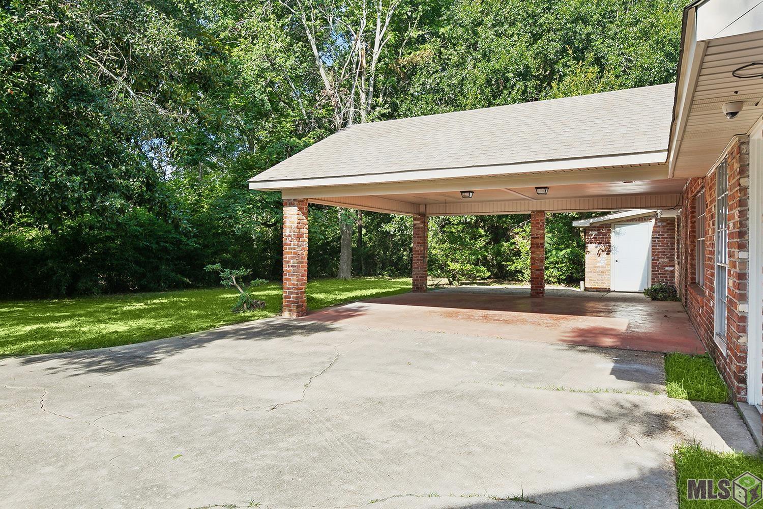 9736 Regency Drive Baton Rouge, LA 70815 - Photo 17 of 19 Carport and more parking. See the storage room