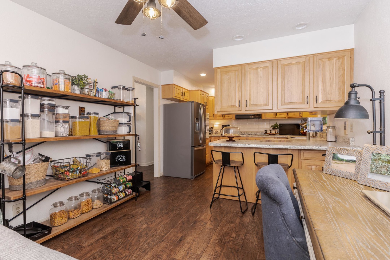 208 Foster Drive Normal, IL 61761 - Photo 11 of 32 a kitchen with stainless steel appliances a stove a refrigerator a sink a stove and white cabinets with wooden floor