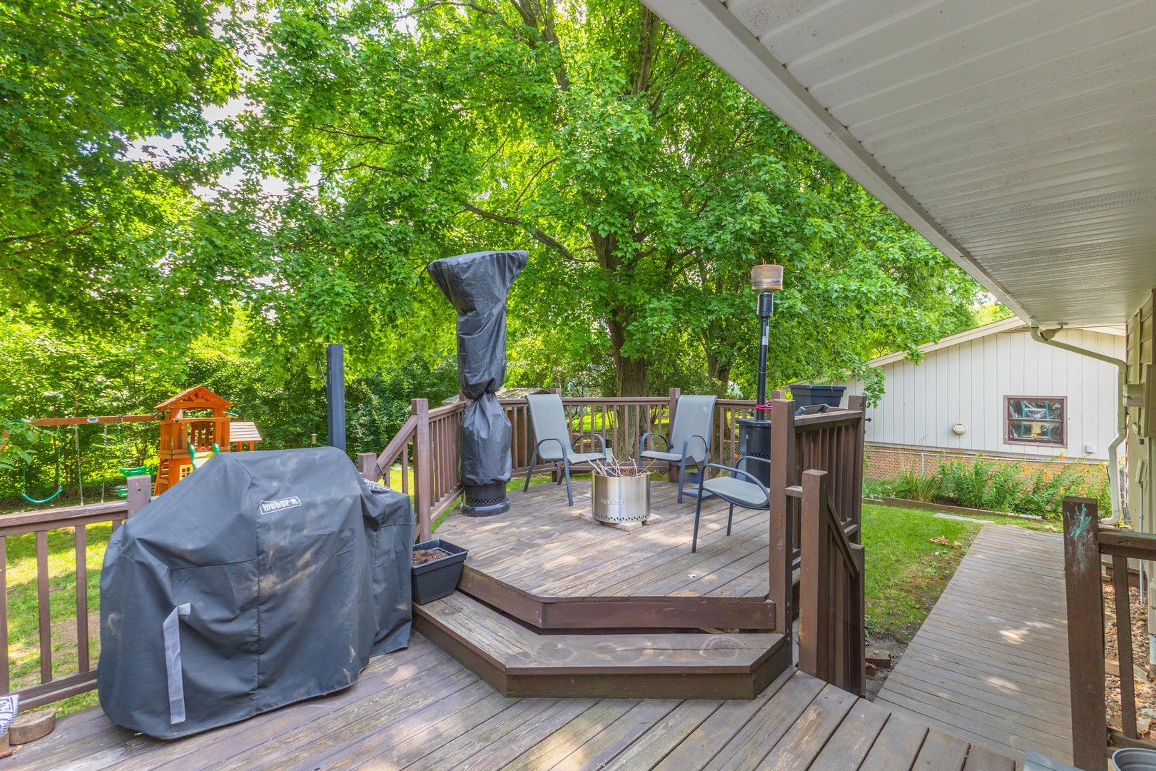 208 Foster Drive Normal, IL 61761 - Photo 28 of 32 a view of a patio with table and chairs potted plants with wooden floor