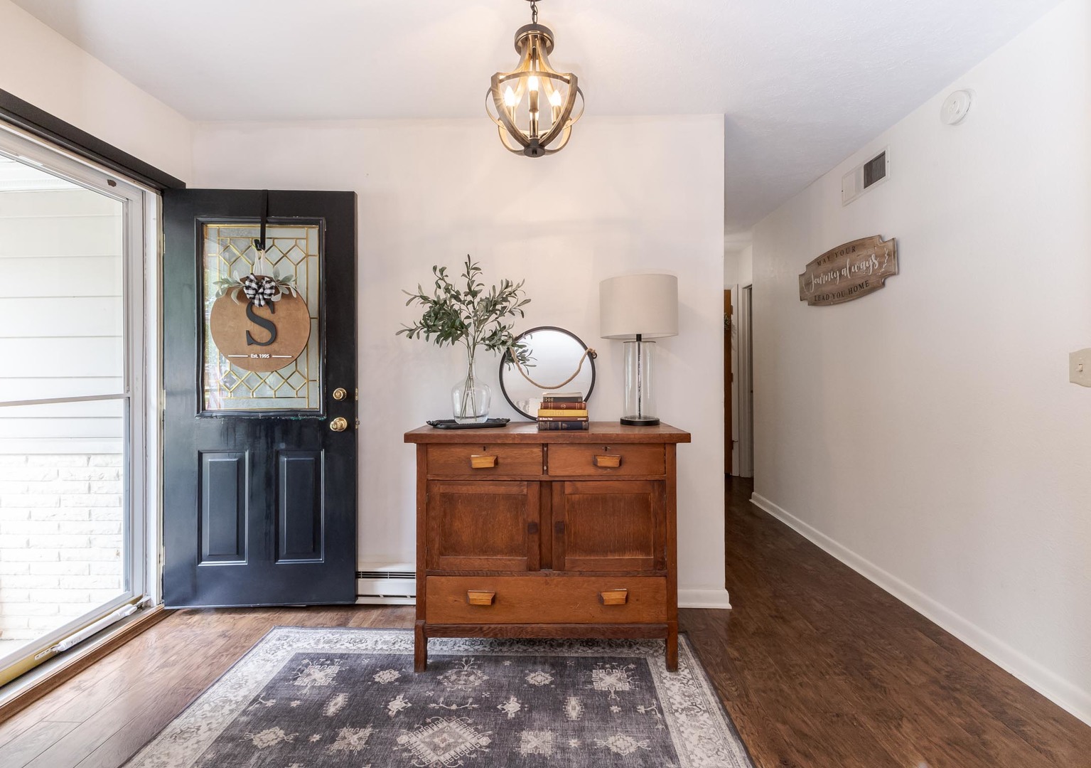 208 Foster Drive Normal, IL 61761 - Photo 3 of 32 a view of a hallway with entryway wooden floor and front door