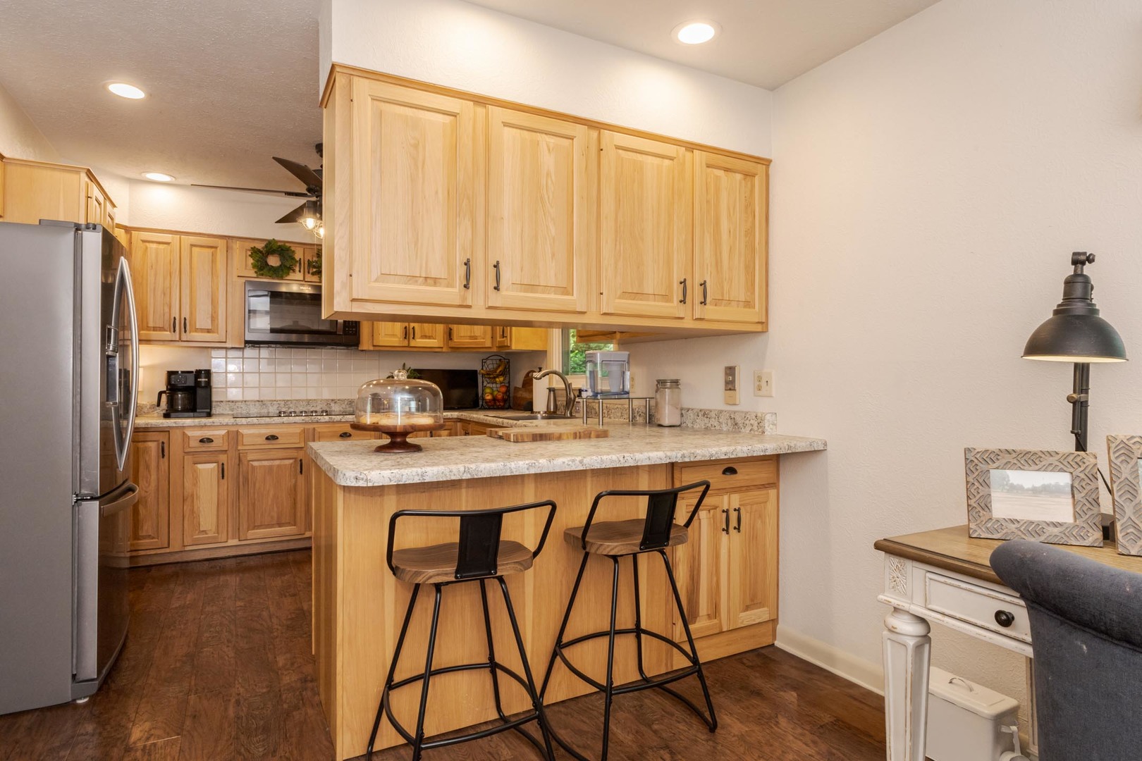 208 Foster Drive Normal, IL 61761 - Photo 9 of 32 a kitchen with stainless steel appliances granite countertop a stove a sink dishwasher and a refrigerator with wooden floor