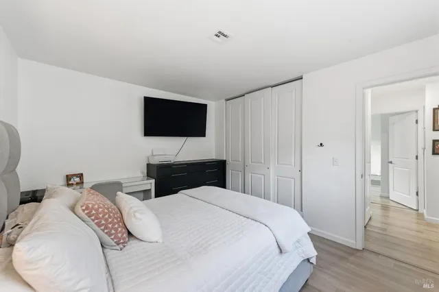 a bedroom with a bed and a flat screen tv