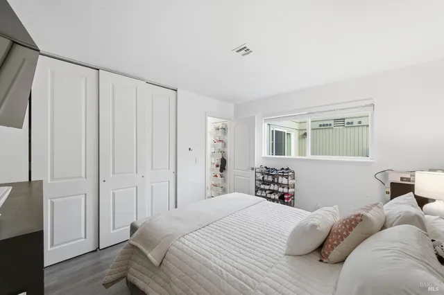 a bedroom with a bed and a window