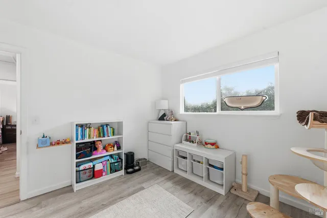 a room with furniture a rug and a lamp