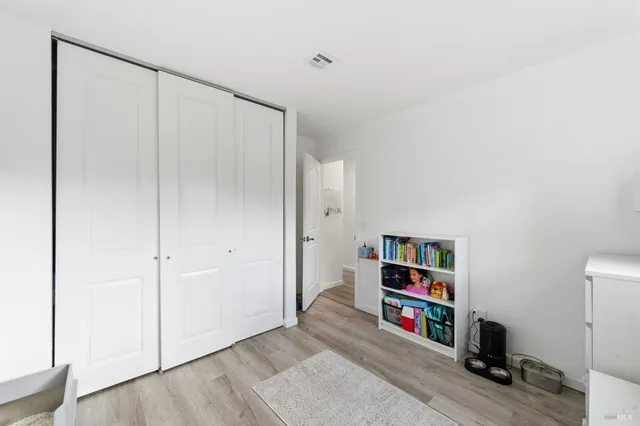 a room with a book shelf and a wooden floor
