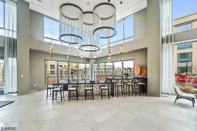 a view of a dining room with furniture and chandelier