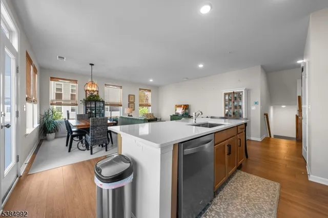 a kitchen with kitchen island a stove a table and chairs in it