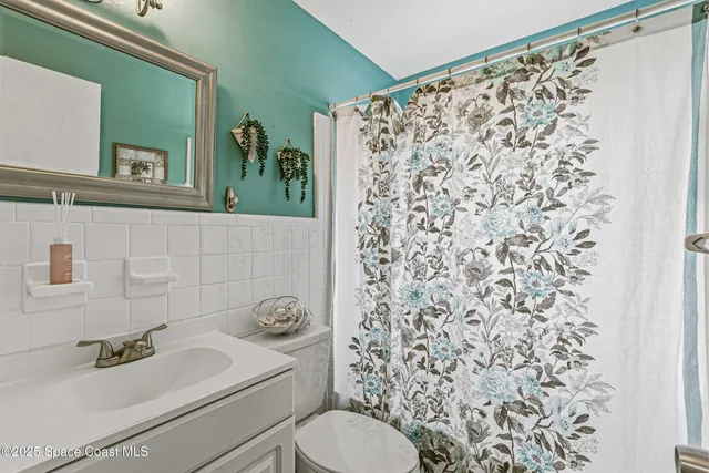 a bedroom with a bed a window and a chandelier