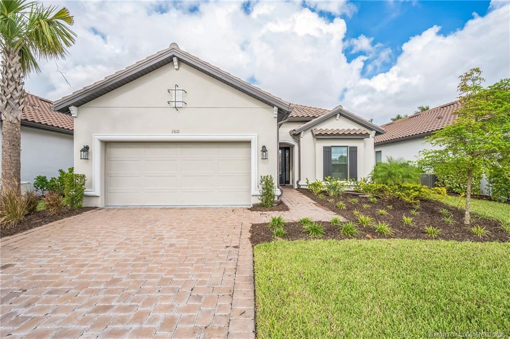 15111 Pescara Street Naples, FL 34114 - Photo 1 of 43 a front view of a house with a yard and garage