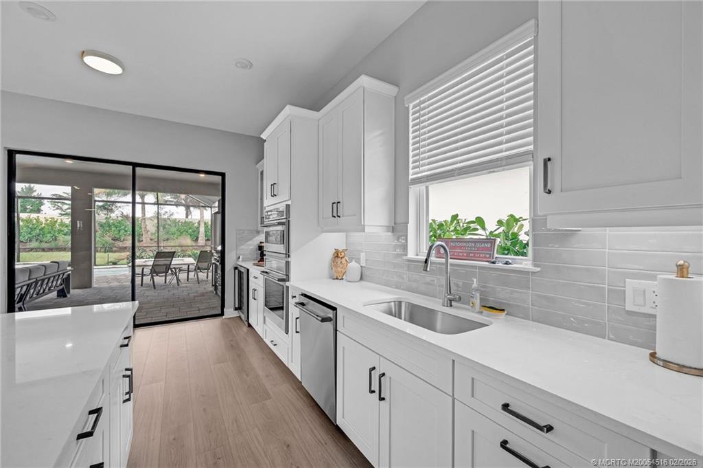 15111 Pescara Street Naples, FL 34114 - Photo 11 of 43 a large white kitchen with a large window