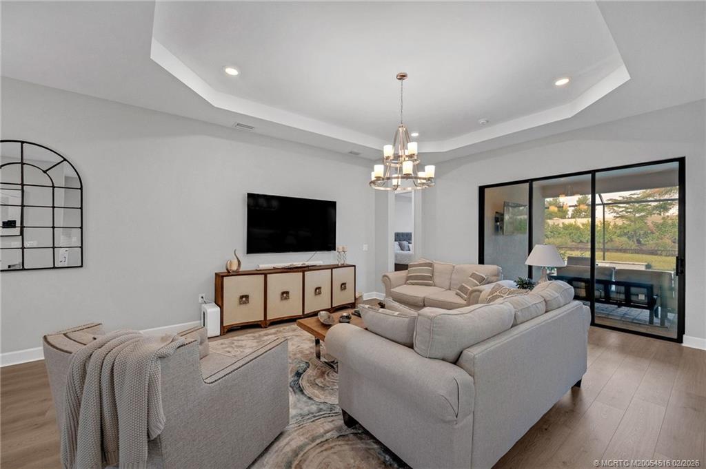 15111 Pescara Street Naples, FL 34114 - Photo 13 of 43 a living room with furniture and a flat screen tv