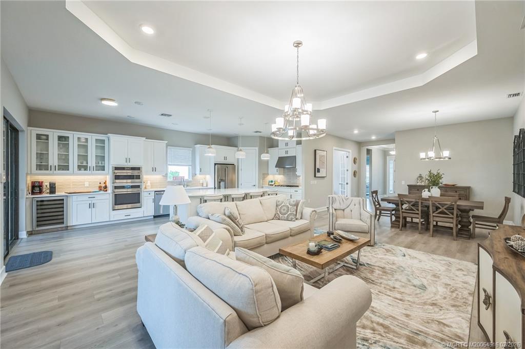 15111 Pescara Street Naples, FL 34114 - Photo 15 of 43 a living room with furniture and a chandelier