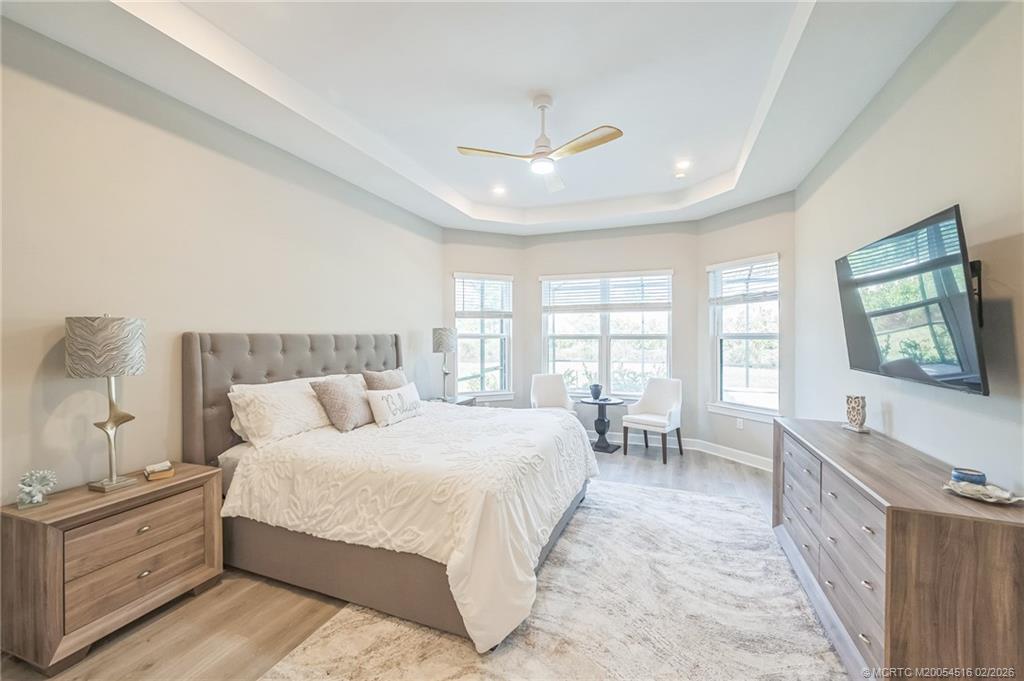 15111 Pescara Street Naples, FL 34114 - Photo 16 of 43 a spacious bedroom with a large bed and a chandelier