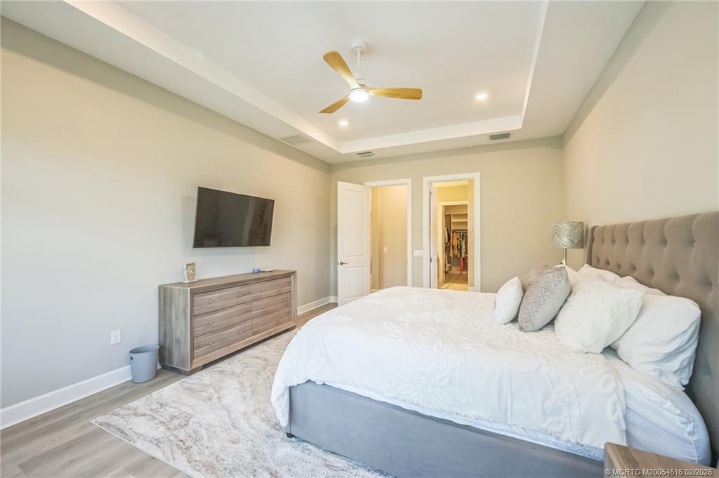 15111 Pescara Street Naples, FL 34114 - Photo 17 of 43 a bedroom with a bed and a flat screen tv