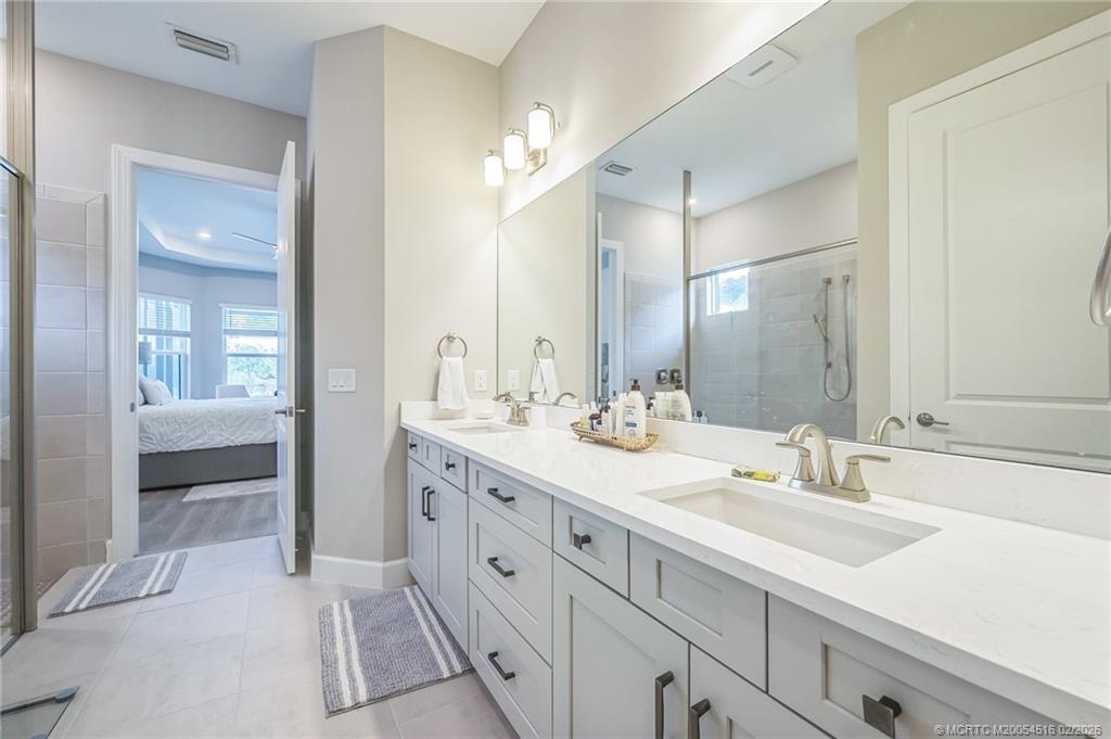 15111 Pescara Street Naples, FL 34114 - Photo 18 of 43 a bathroom with a sink double vanity and a mirror