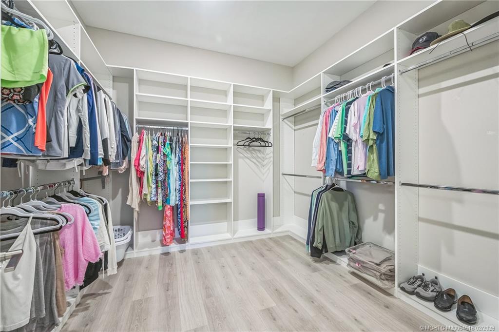 15111 Pescara Street Naples, FL 34114 - Photo 20 of 43 a view of walk in closet with clothes and shoes