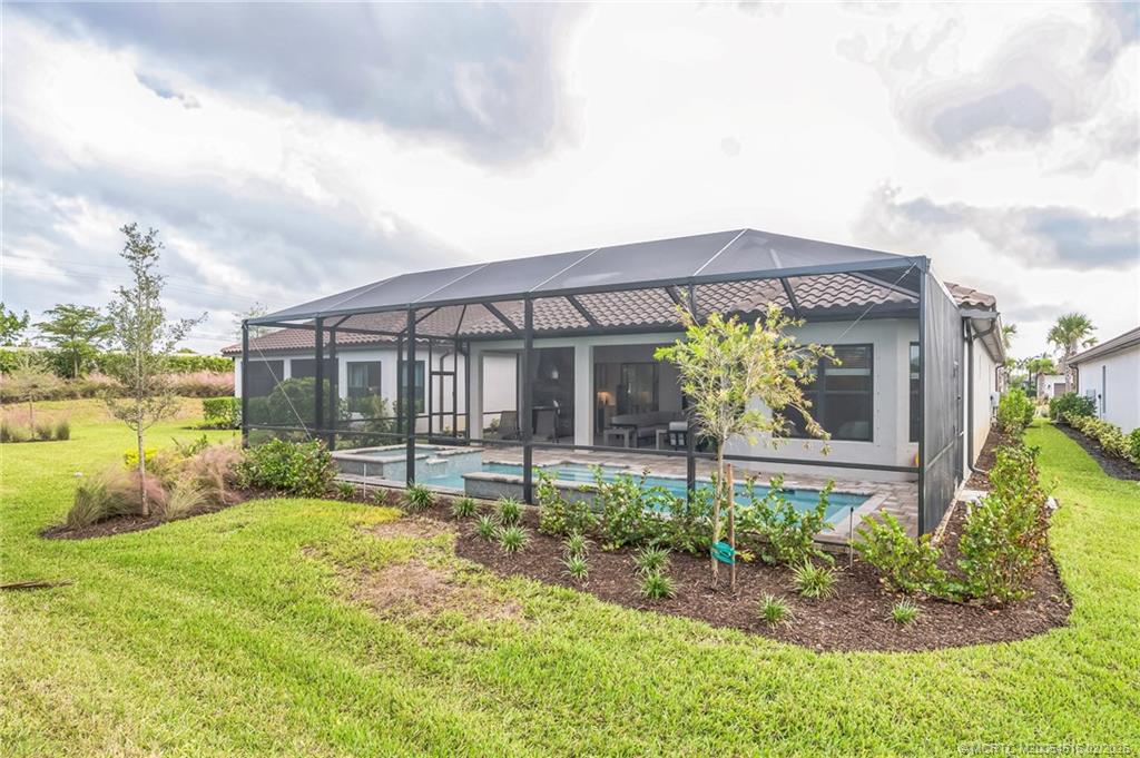 15111 Pescara Street Naples, FL 34114 - Photo 3 of 43 a front view of a house with garden