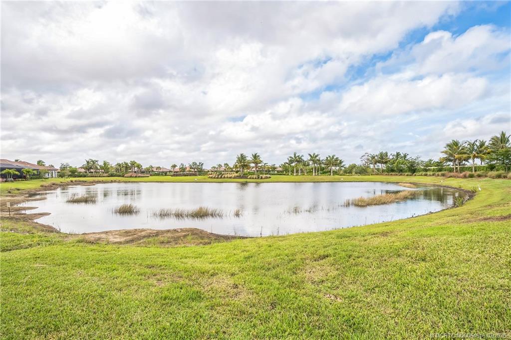 15111 Pescara Street Naples, FL 34114 - Photo 32 of 43 a view of a lake with a big yard
