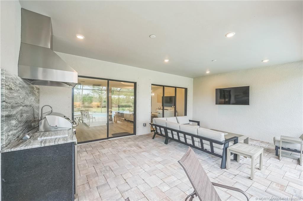 15111 Pescara Street Naples, FL 34114 - Photo 35 of 43 a spacious bedroom with a bed and a large window