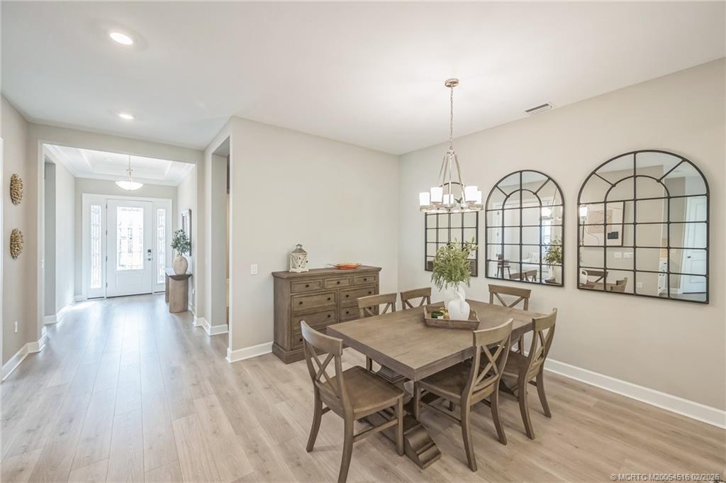 15111 Pescara Street Naples, FL 34114 - Photo 5 of 43 a view of a dining room with furniture window and wooden floor